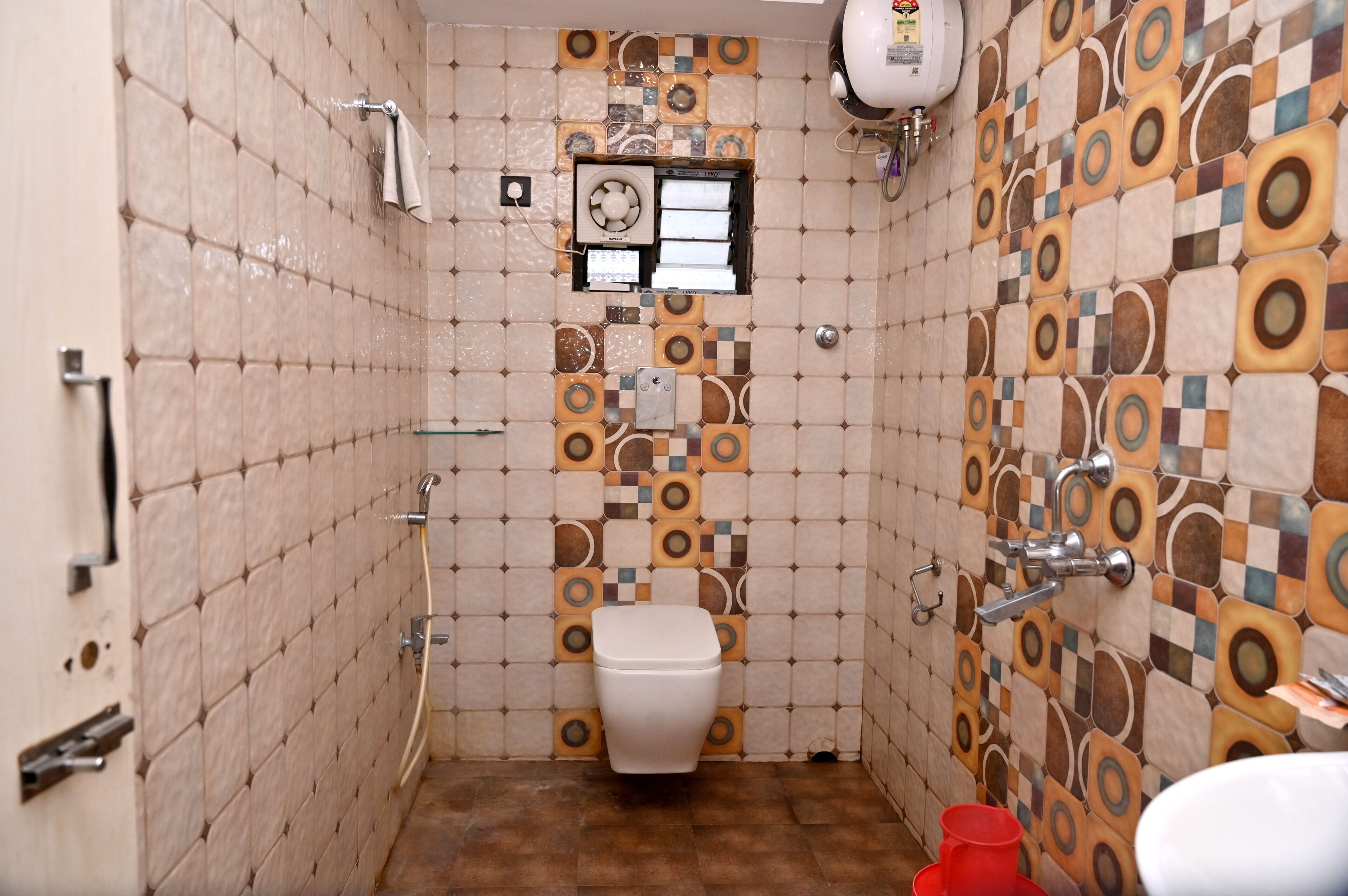 A bathroom with a toilet, a shower, and a sink.