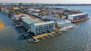 A waterfront hotel with multiple buildings, docks, and boats.