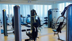 A gym with various exercise machines, a mirrored wall, and a treadmill. - Midtown Fully Furnished Apartments - Great Location 2 Bedroom Apts by RedAwning (Atlanta)