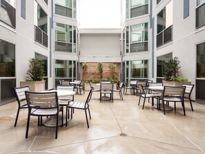A courtyard with outdoor seating and planters.