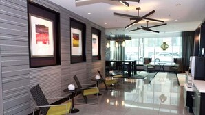 A modern lobby with a reception desk, seating area, and artwork on the walls. - 2br Furnished Apartment In Baltimore Downtown 2 Bedroom Apts by RedAwning (Baltimore)