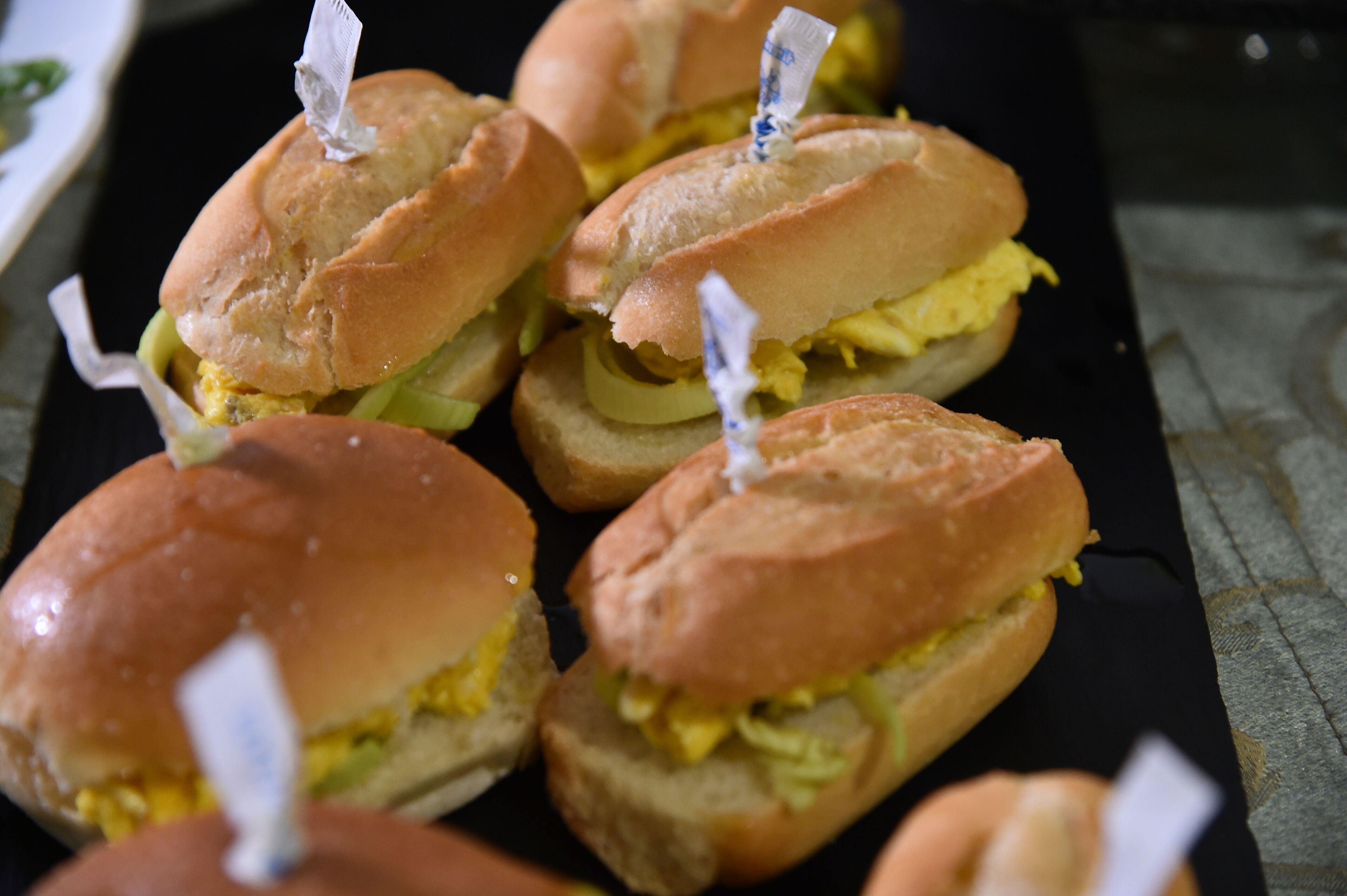 Un plateau de sandwichs dont on peut voir la garniture, avec des cure-dents.