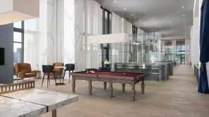Relax and socialize in this spacious room with a pool table, seating area, and large window.