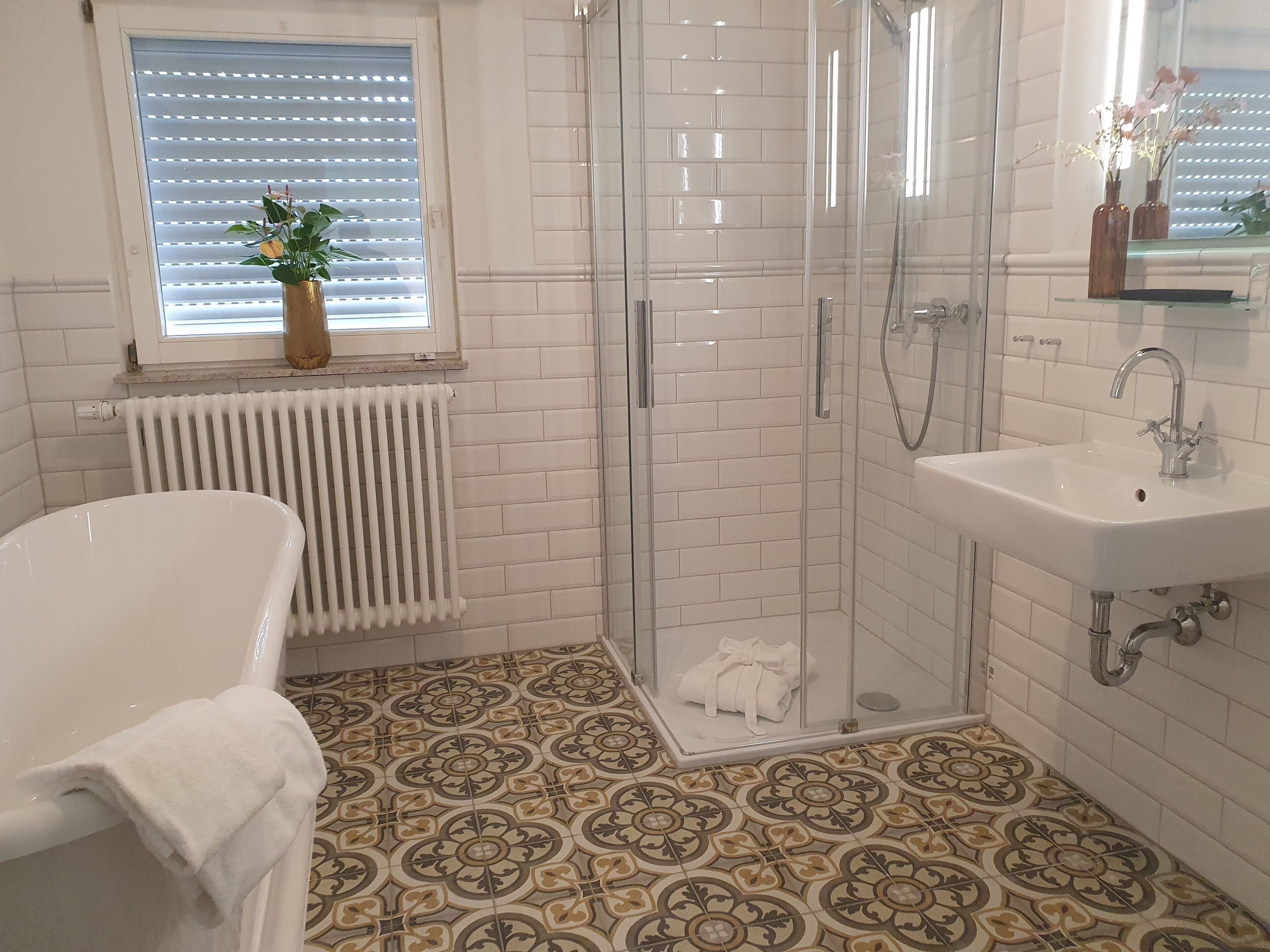 A bathroom with a shower, a sink, and a bathtub.