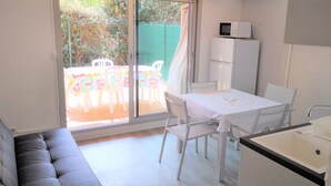 A compact kitchen with a white refrigerator, a microwave on top, and a sink. - 2-room apartment Résidence Provençale Air-conditioned Parking Pool 2 km Sea (Villeneuve-Loubet)