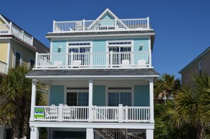 A two-story house with a balcony on the upper floor, a visible 'Dimes Realty' sign, and a 'Rental' sign. - Sandy Paws - Oceanfront in Surfside Beach, SC (Surfside Beach)