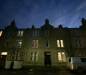 Stylish residential building with a traditional facade and evenly spaced windows.