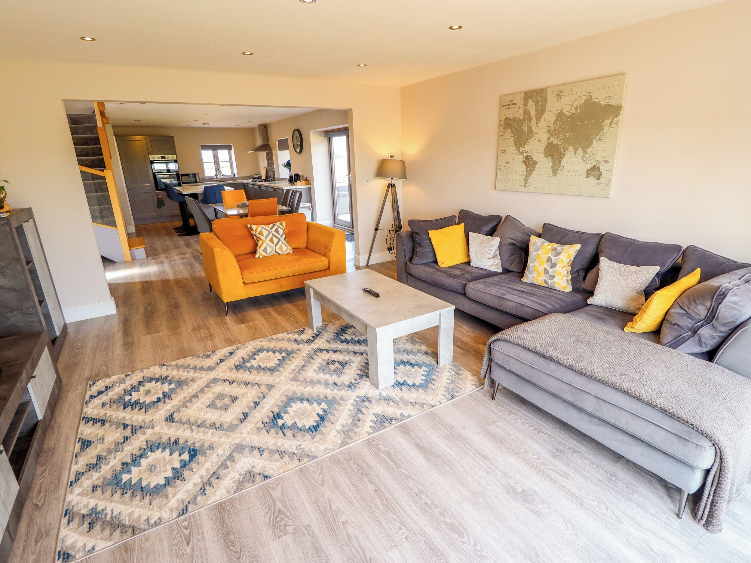 A spacious living area with a sofa, coffee table, and a patterned rug.