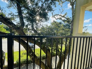 Enjoy a serene view of the beautifully maintained garden from this balcony.
