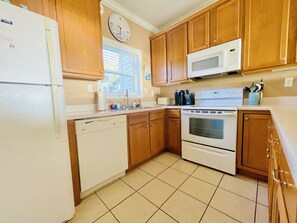 Enjoy cooking in this well-equipped kitchen with a dishwasher, oven, microwave, and sink.