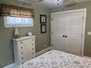 A bedroom with a large wardrobe, a dresser, and a patterned carpet. - Newly renovated 3 bedroom, 2 bath bungalow, just steps to downtown BBH. (Boothbay Harbor)