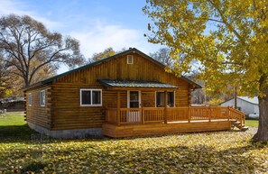 A wooden cabin with a porch and a small deck. - Base Camp Cabin on Main (Hyattville)