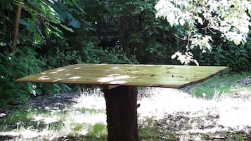 Enjoy a meal amidst nature at this serene outdoor dining space.