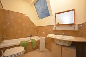 Kombination af bruser/badekar, hårtørrer, bidet, håndklæder