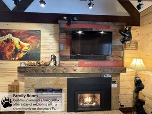 Relax and unwind in this family room with a fireplace, flat-screen TV, and cozy decor.