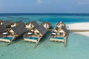Overwater bungalows with infinity pools, wooden walkways, and a clear view of the ocean. - Emerald Faarufushi Resort & Spa (Faarufushi)