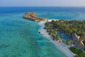 An aerial view of a resort with overwater bungalows, a beach, and a pool area. - Emerald Faarufushi Resort & Spa (Faarufushi)