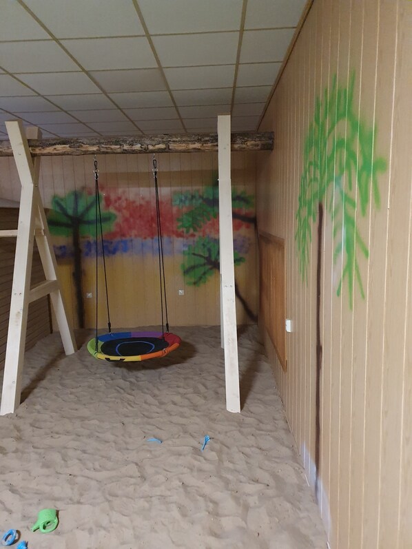 A room with a swing set, a wall mural, and a ladder. - Stettiner Hof (Eggesin)