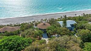 A coastal property with a beach view, a gazebo, and a house with a blue roof. - The Turtle House-Miles and Miles of Private Beach-Sunset Views! (Englewood)