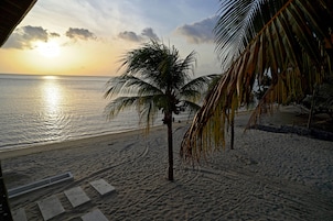 On the beach, white sand, sun loungers, beach towels