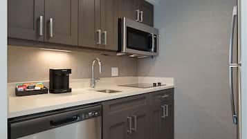 A modern kitchen with stainless steel appliances, a dishwasher, and a coffee maker.