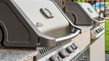 A barbecue grill with a control panel and a logo.