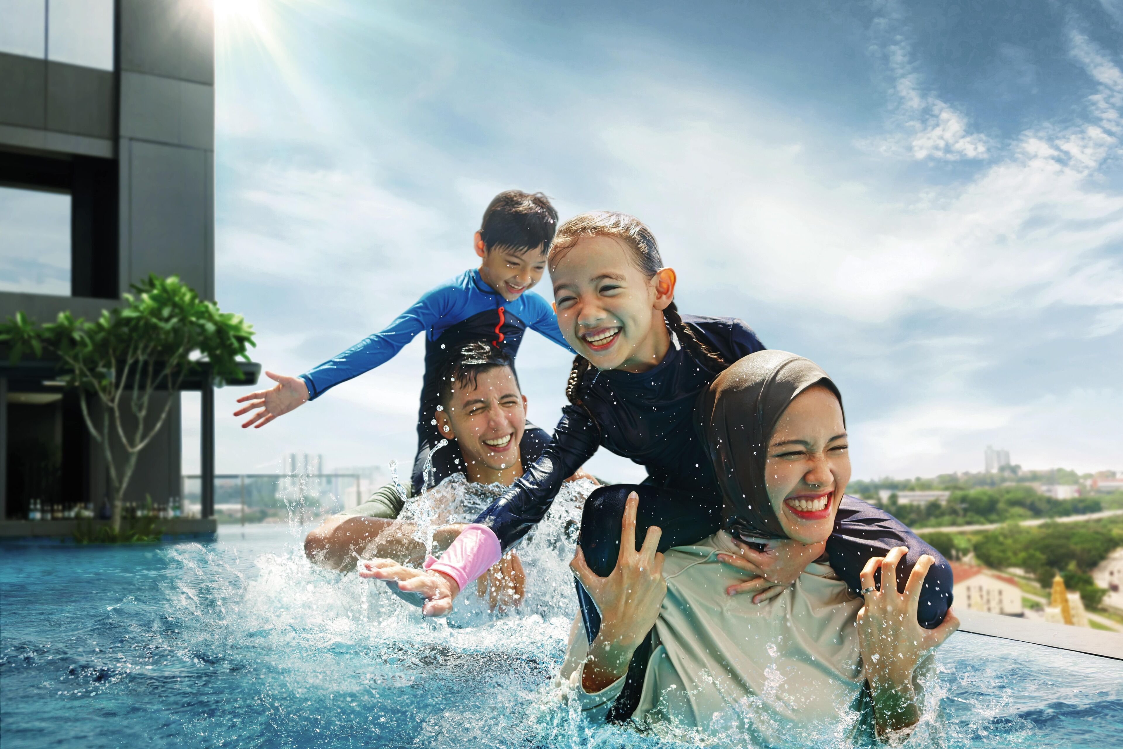 A group of people in a swimming pool with a modern building in the background.