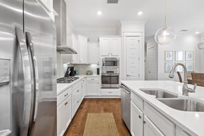 Enjoy cooking in this well-equipped kitchen with a central island, oven, and stovetop.