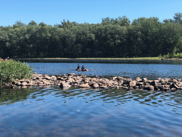 A calm river with rocks and trees in the background. - Waterfront Ranch on The Delaware River (Matamoras)