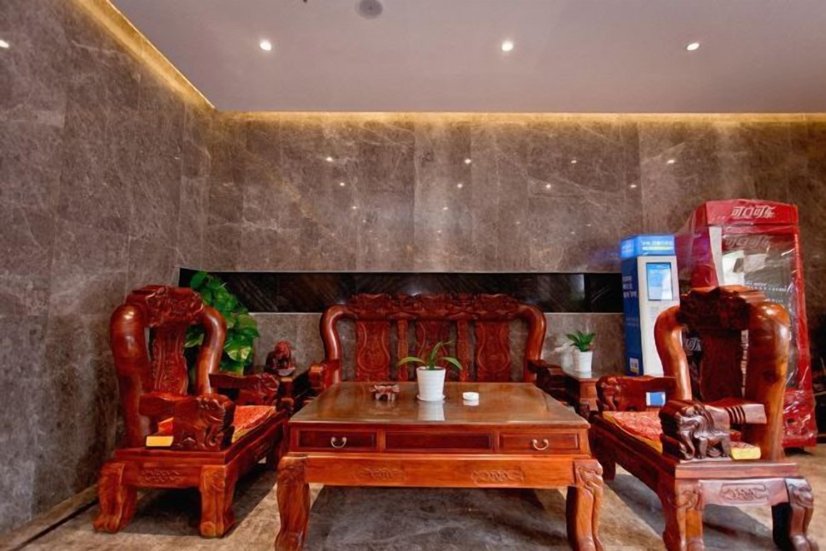 A room with a wooden table and chairs, a flat-screen TV, and a red box on the right.