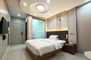 A modern bedroom with a bed, bedside table, and a built-in TV. - Suzhou Jiale Hotel (Suzhou)