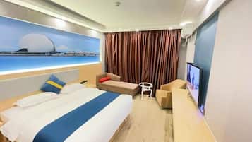 A hotel room with a large bed, a desk, a TV, and a view of a bridge.