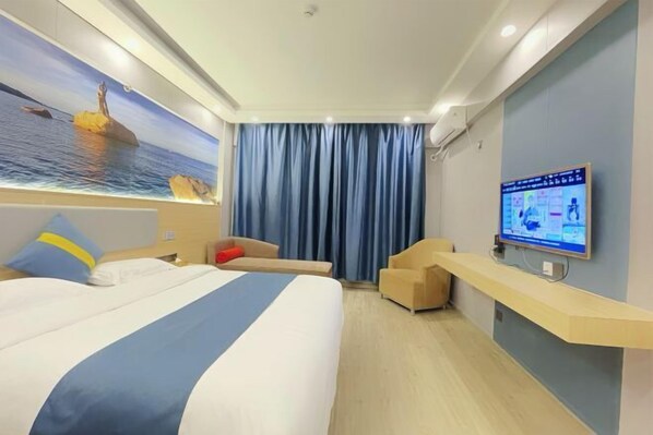 A hotel room with a bed, a TV on a stand, a desk, and a large window with curtains. - Zhuhai Xinhong Hotel (Daxin Xinduhui Branch) (Zhuhai)