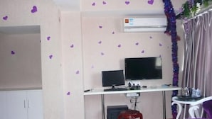 A room with a desk, a television, a chair, and a wardrobe. - Yaocheng Hotel (Shanghai)