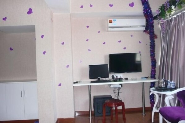 A room with a desk, a television, a chair, and a wardrobe. - Yaocheng Hotel (Shanghai)
