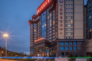 A multi-story hotel with a prominent sign indicating it is a hotel and a business center.