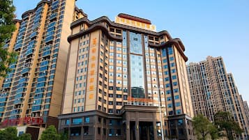 A multi-story hotel with a prominent entrance, large windows, and a modern architectural design.