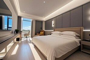 A modern bedroom with a large bed, bedside tables, a desk, and a chair. - Yangguang Express Hotel (Xiushan County)
