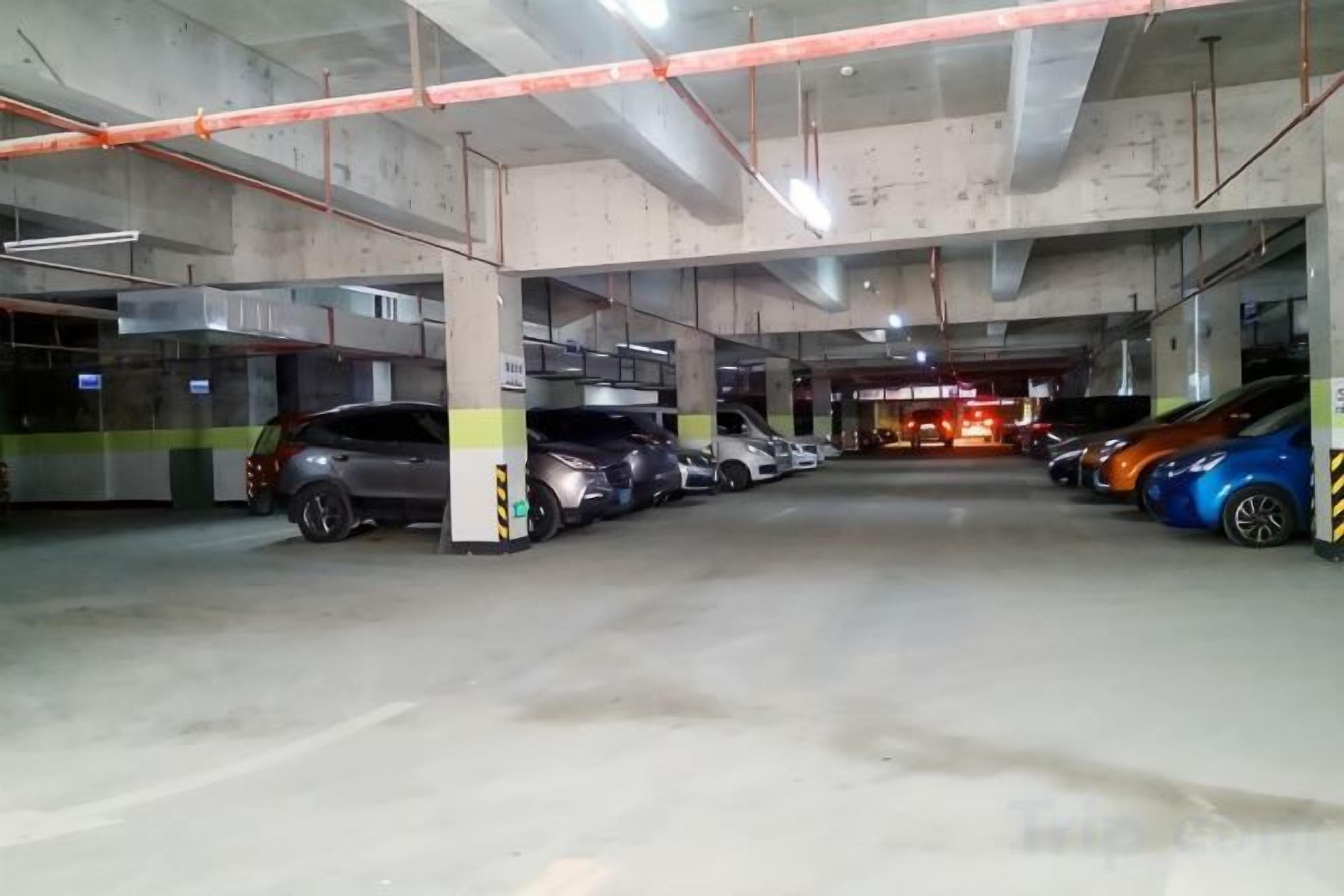 A multi-level parking garage with several cars parked.