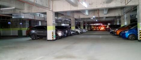 A multi-level parking garage with several cars parked.