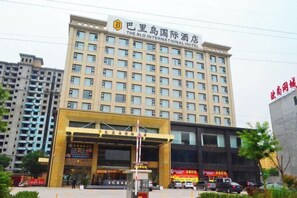 A multi-story hotel building with a prominent entrance and signage.