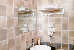 A bathroom with a sink, mirror, towel rack, and a hairdryer. - Guilin Guzhen Inn (Dawei Guzhen Inn) (Lingchuan)