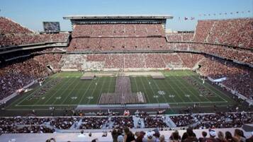 A large stadium with multiple tiers of seating and a football field.