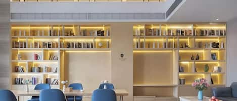 A modern interior with a dining area, bookshelves, and a coffee table.