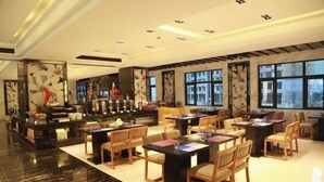 A spacious hotel lobby with a bar area, multiple seating arrangements, and large windows providing natural light. - Mellow Crystal Hotel (Zhangjiajie)
