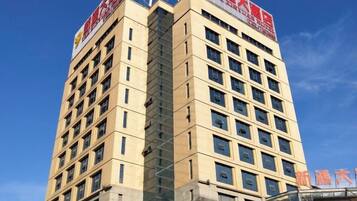 A multi-story hotel building with a clear sky in the background.