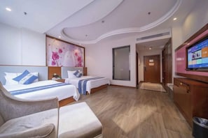 A hotel room with two beds, a TV, a seating area, and a large window. - Lang Ting Hotel (Shaoyang)
