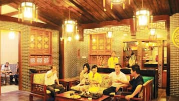 A traditional-style interior with wooden furniture and hanging lanterns.