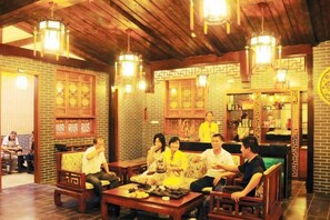 A traditional-style interior with wooden furniture and hanging lanterns. - Y. H. Continental Grand Hotel (Jiangle)