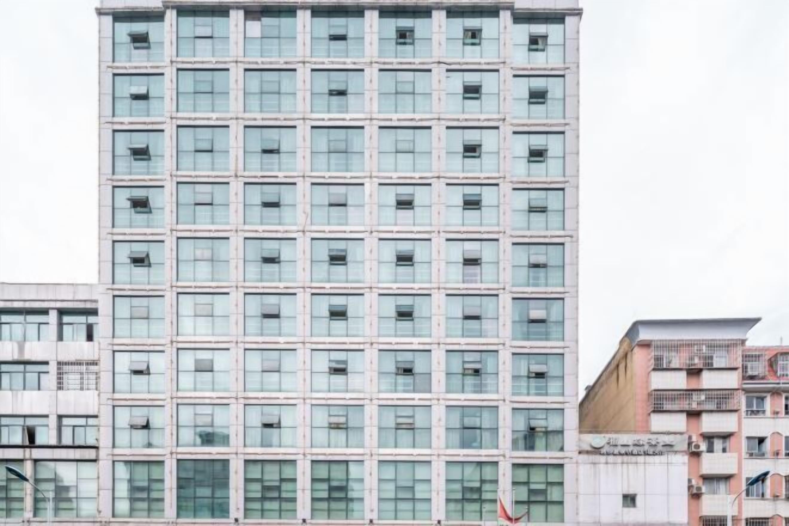 A high-rise building with a grid of windows and a flat facade.